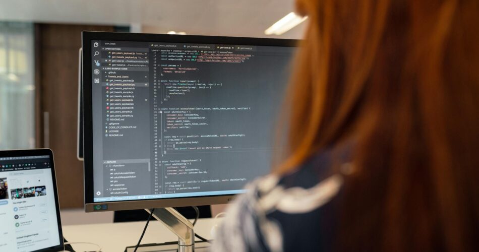 female software engineer coding on computer