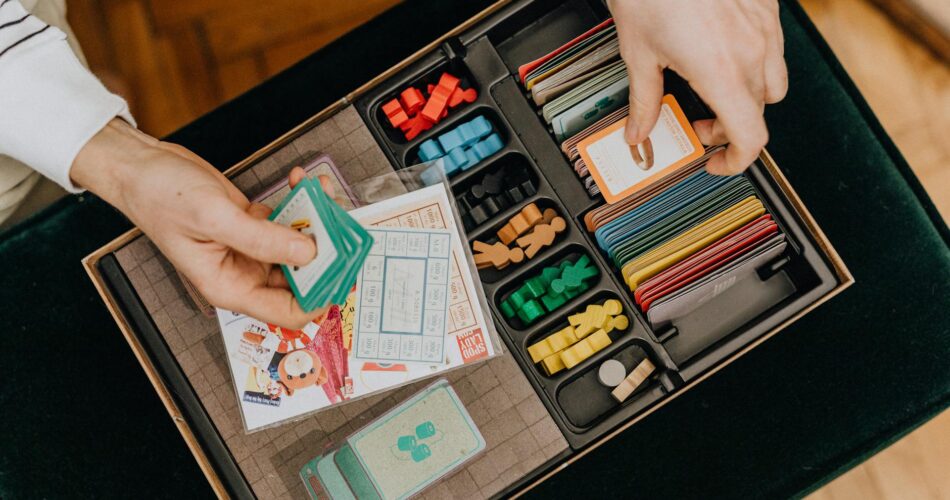 close up of hands playing board game