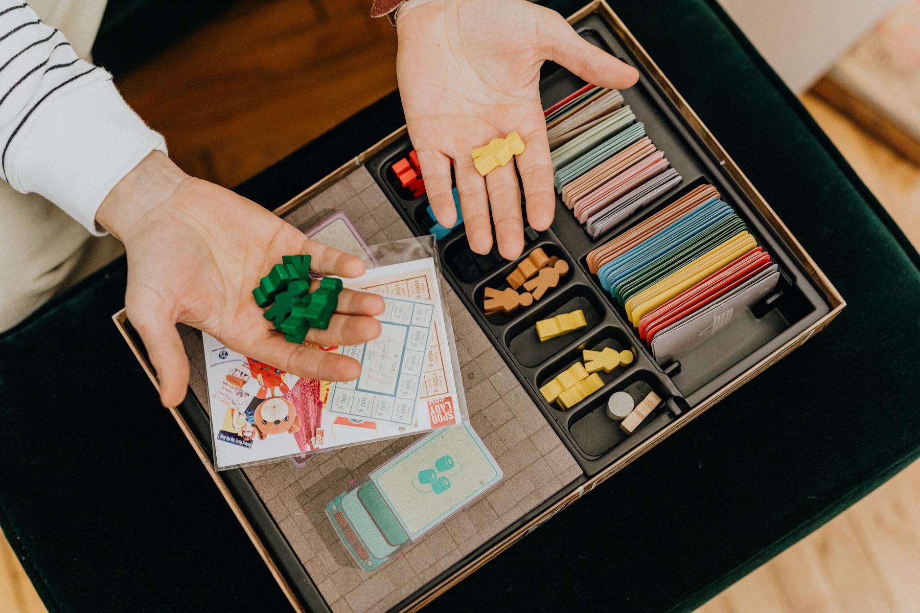 top view of man holding counters from a vintage board game
