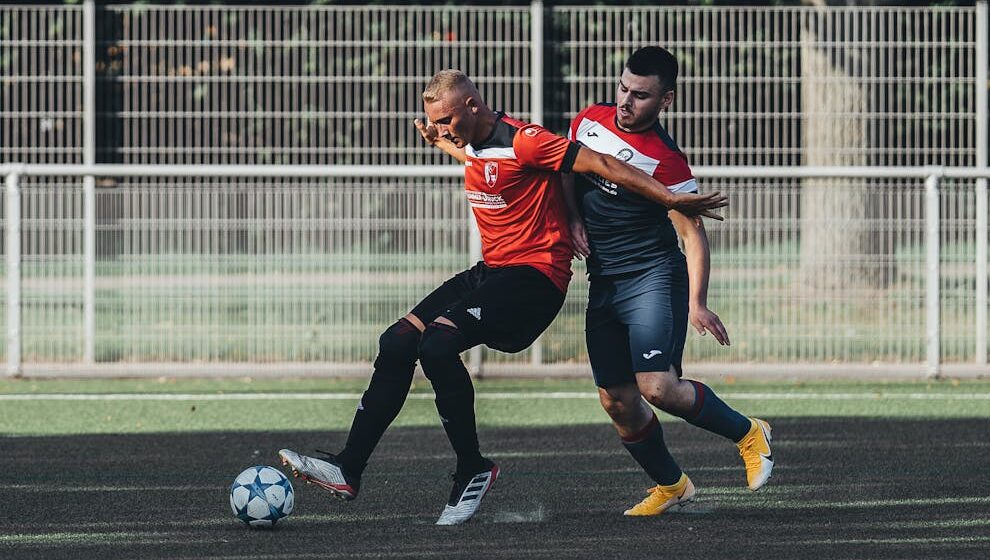 a man defending the ball from his opponent