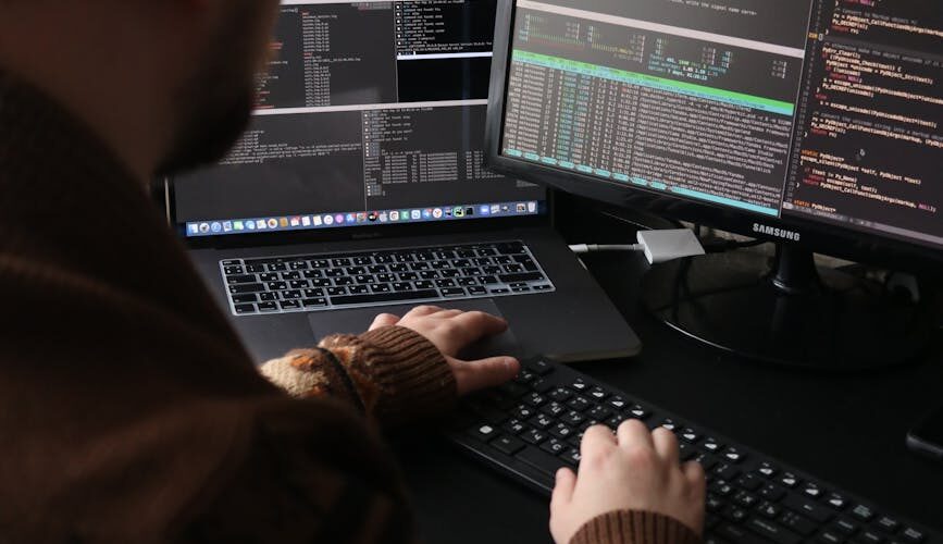person in brown long sleeve shirt typing on a keyboard